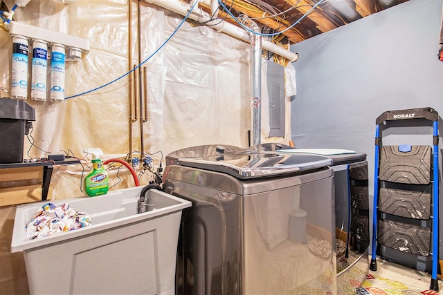 clothes washing area featuring separate washer and dryer