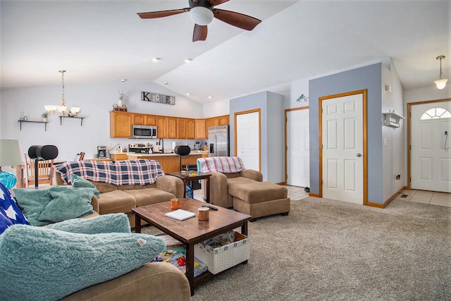 carpeted living room featuring ceiling fan with notable chandelier, sink, and vaulted ceiling