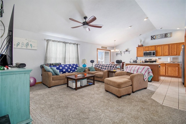 carpeted living room with ceiling fan with notable chandelier and lofted ceiling