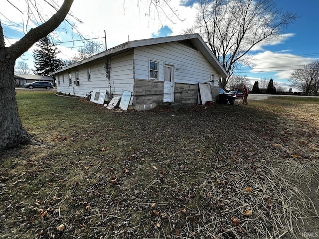 view of property exterior featuring a lawn