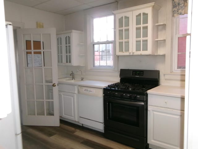 kitchen with a drop ceiling, white appliances, white cabinets, sink, and dark hardwood / wood-style floors