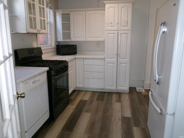 kitchen featuring white cabinetry, dark wood-type flooring, and black appliances