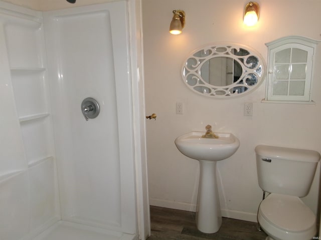 bathroom with hardwood / wood-style floors and toilet