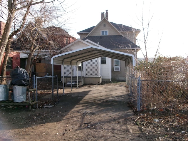 exterior space with a carport and cooling unit