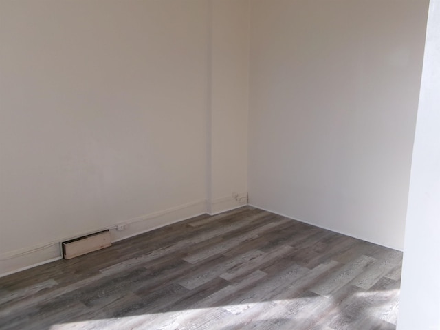 unfurnished room featuring dark hardwood / wood-style flooring