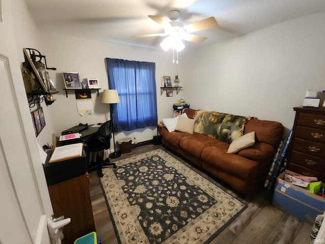 living room featuring ceiling fan and dark hardwood / wood-style flooring