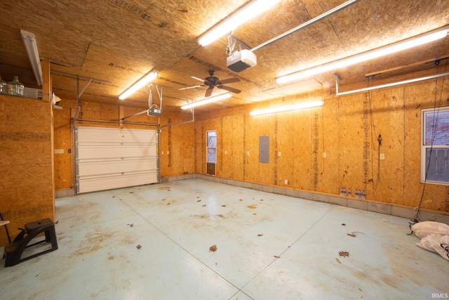 garage with electric panel and a garage door opener