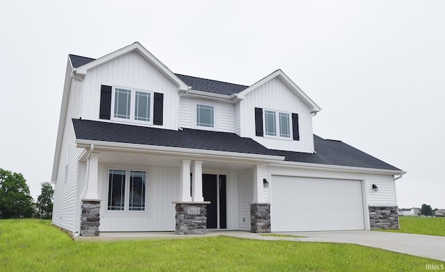 view of front of home with a front yard, a porch, and a garage