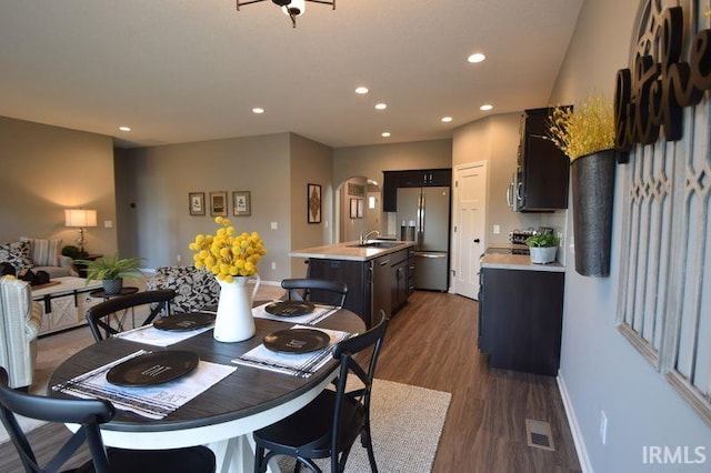 dining area with sink and dark wood-type flooring