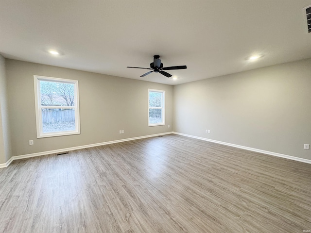 unfurnished room featuring hardwood / wood-style flooring and ceiling fan