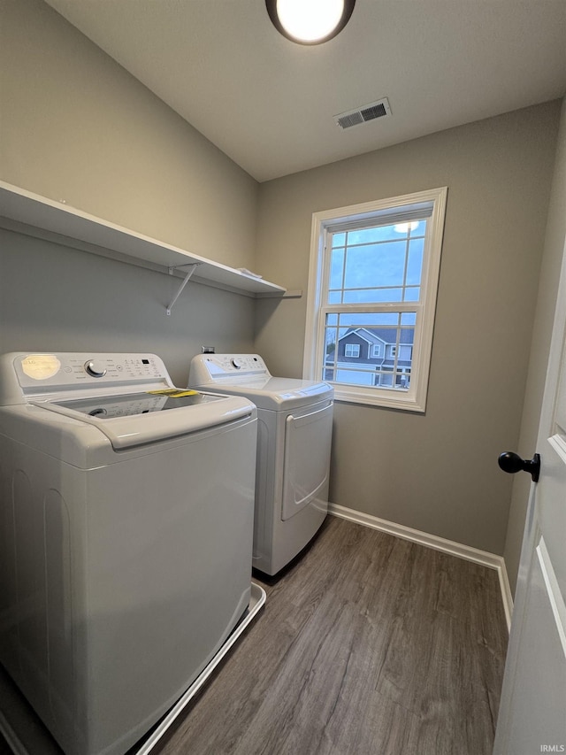 washroom featuring wood-type flooring and independent washer and dryer