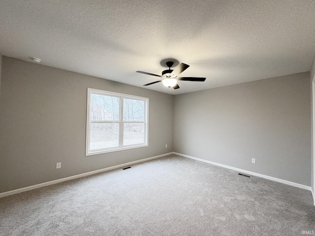 unfurnished room featuring carpet, ceiling fan, and a textured ceiling