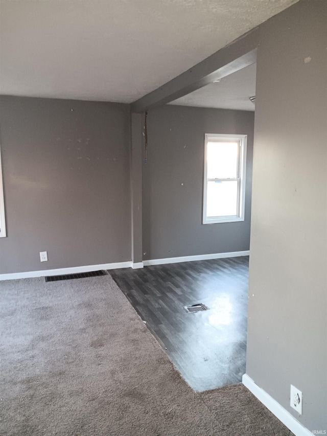 spare room featuring dark hardwood / wood-style floors