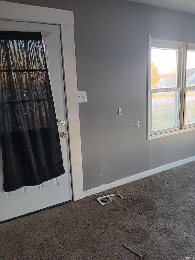 view of carpeted foyer entrance