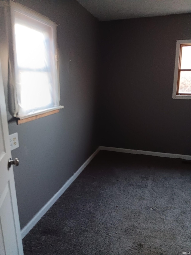 empty room with dark carpet