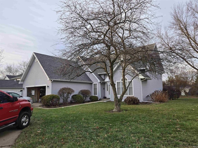 front of property with a garage and a front lawn