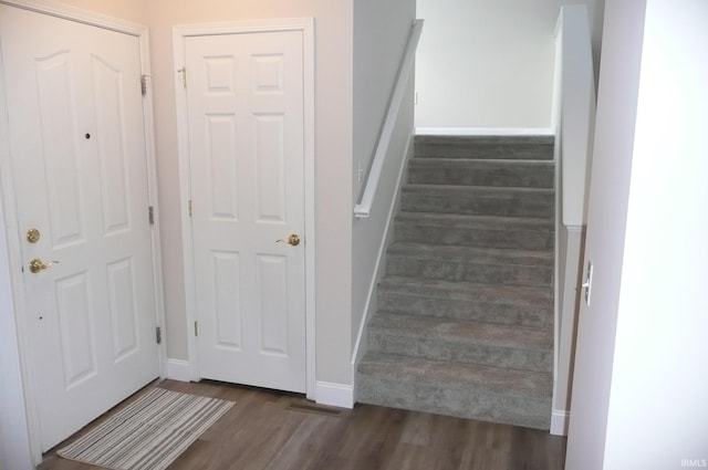 stairs featuring hardwood / wood-style flooring