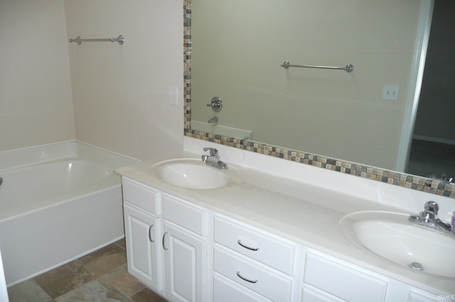 bathroom with a bathing tub and vanity