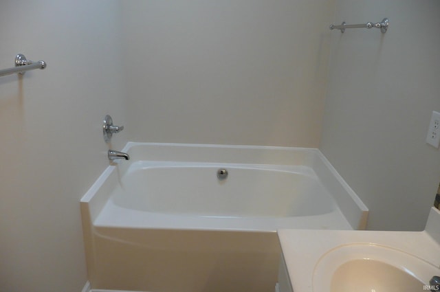 bathroom featuring vanity and a tub to relax in