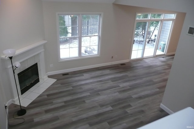 unfurnished living room featuring hardwood / wood-style floors and a fireplace