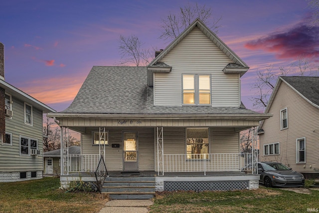 view of front facade featuring a lawn and covered porch