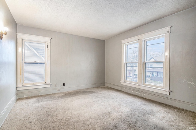 unfurnished room featuring carpet and a textured ceiling