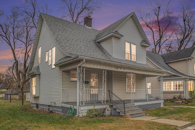 view of front of property with a lawn and a porch