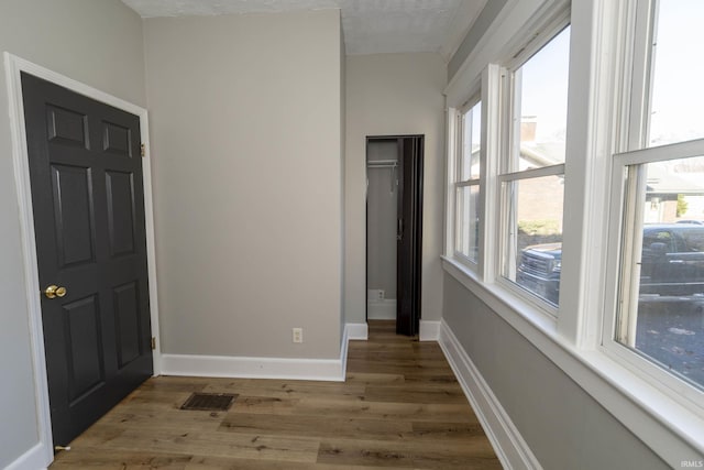 interior space with light wood-type flooring and a textured ceiling