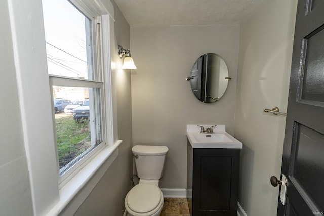 bathroom with vanity, a textured ceiling, and toilet