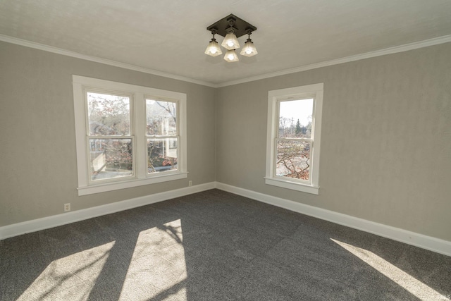 empty room featuring an inviting chandelier, dark carpet, plenty of natural light, and ornamental molding