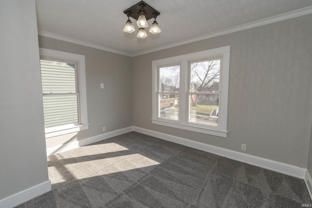 empty room with dark carpet, ornamental molding, and a notable chandelier