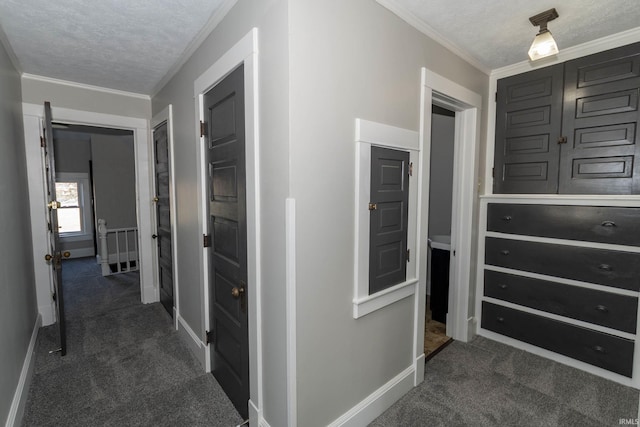 hallway with dark colored carpet, a textured ceiling, and ornamental molding