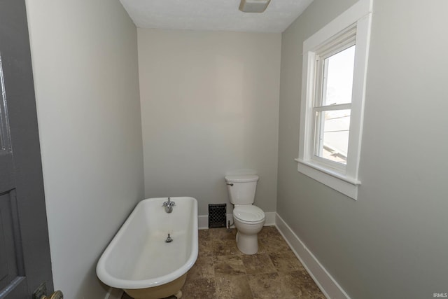 bathroom with a bath and toilet