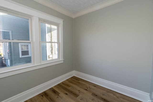 empty room featuring hardwood / wood-style flooring, ornamental molding, and a textured ceiling