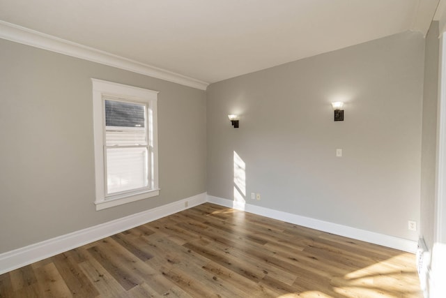 empty room with crown molding and hardwood / wood-style flooring