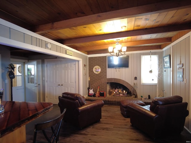 living room featuring beamed ceiling, wood ceiling, hardwood / wood-style flooring, and a brick fireplace