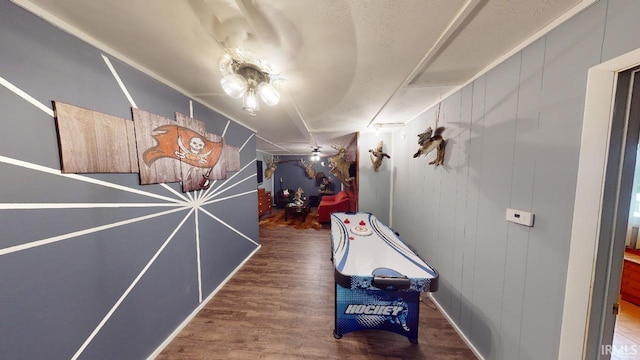 hallway featuring hardwood / wood-style floors and wood walls