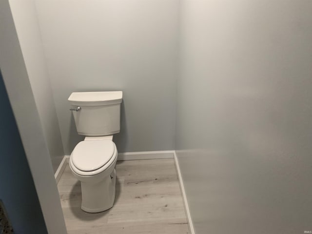 bathroom with wood-type flooring and toilet