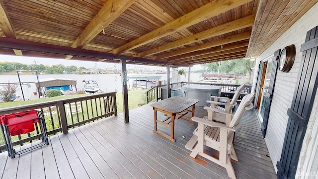 deck featuring a water view and a lawn