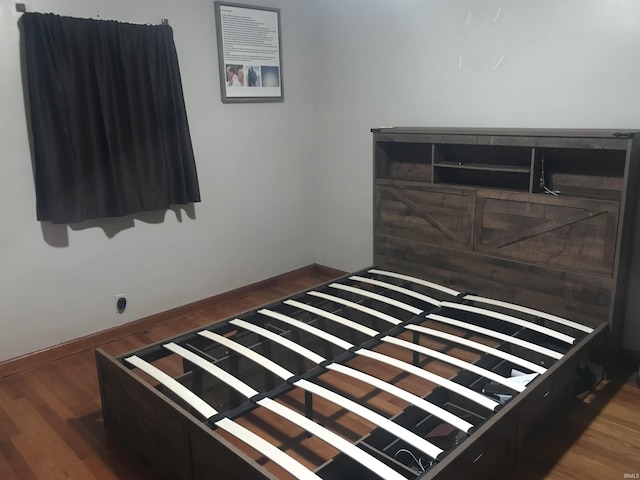 bedroom featuring dark hardwood / wood-style flooring