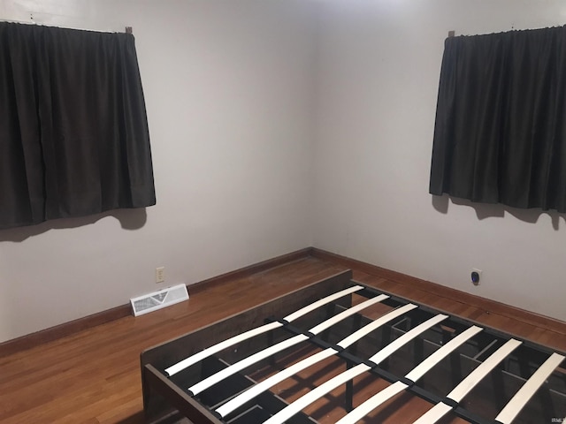 empty room with hardwood / wood-style flooring