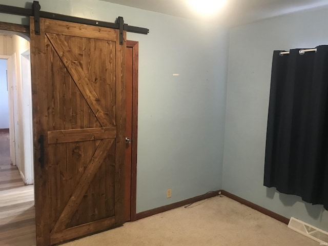 spare room featuring hardwood / wood-style floors and a barn door