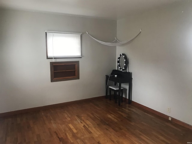 spare room with dark wood-type flooring