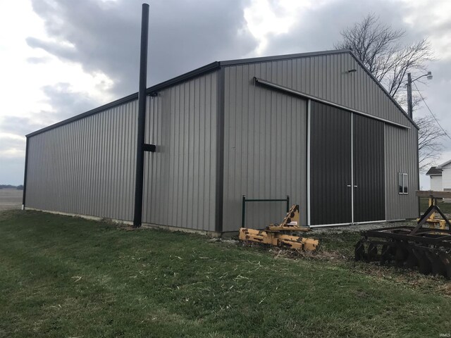 view of outbuilding featuring a lawn