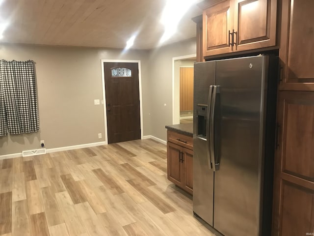 kitchen featuring stainless steel refrigerator with ice dispenser and light hardwood / wood-style flooring