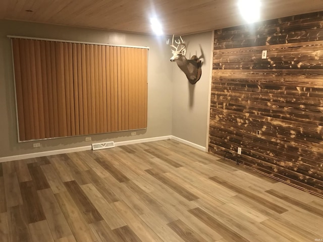 empty room featuring wood ceiling and hardwood / wood-style flooring