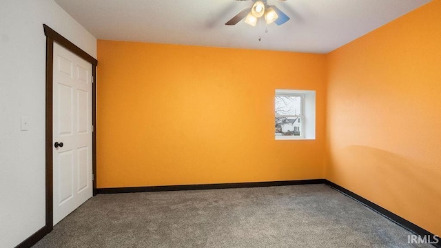 carpeted spare room with ceiling fan