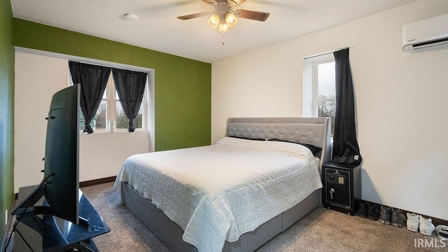 carpeted bedroom featuring ceiling fan, multiple windows, and a wall mounted AC