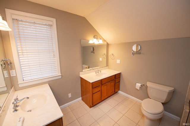 bathroom featuring tile patterned flooring, vanity, toilet, and lofted ceiling