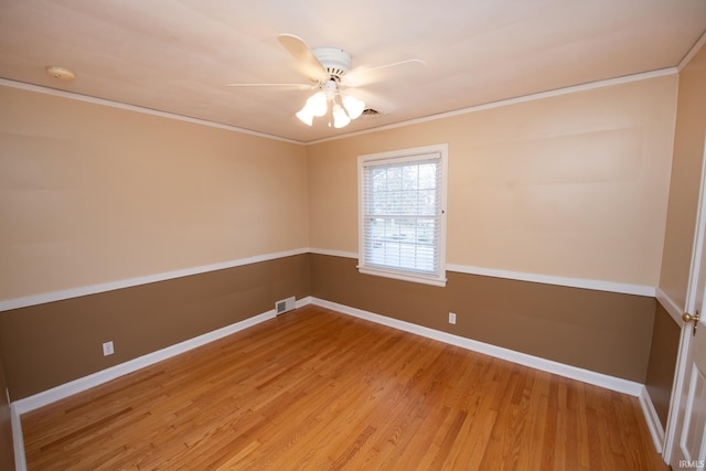 empty room with ceiling fan, wood-type flooring, and ornamental molding